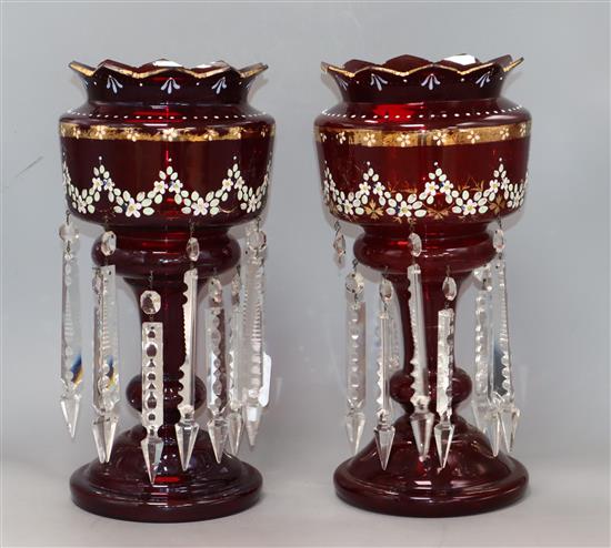 A pair of cranberry glass lustres height 37cm